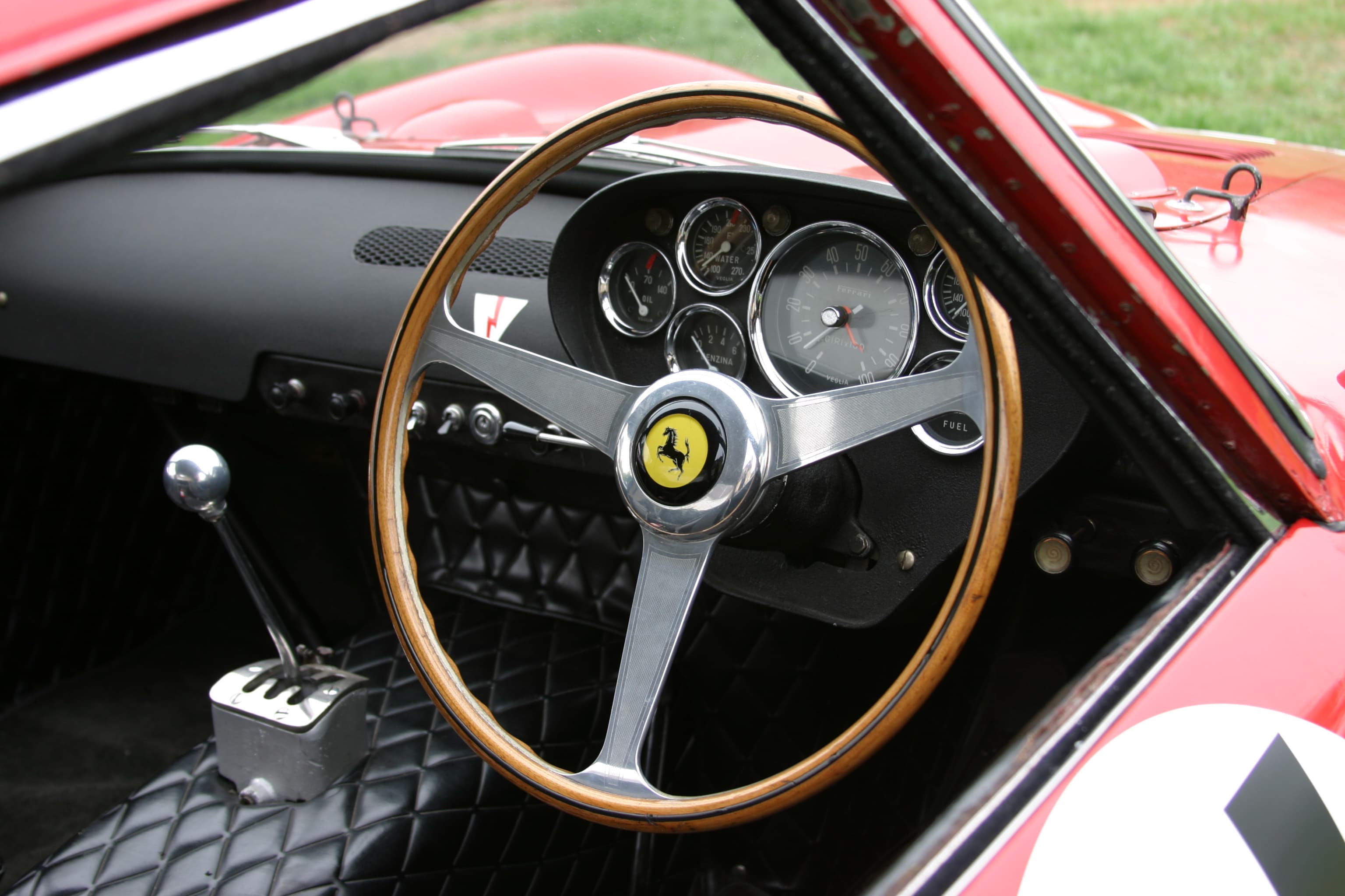Right-hand-drive cockpit of Ferrari 250 GTO chassis 3647GT, showing instruments, steering wheel and gear lever.